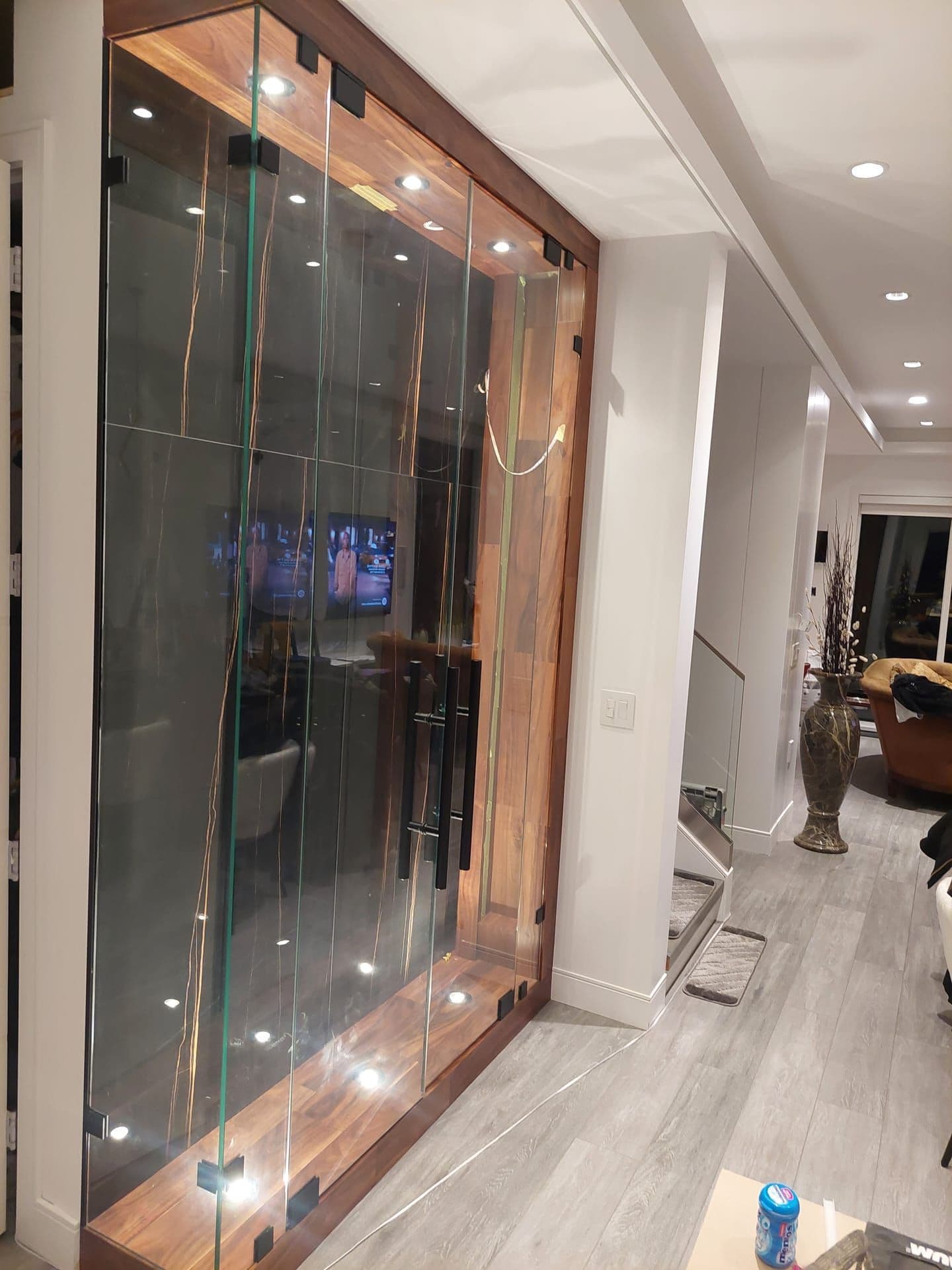 Custom wine cellar with walnut and glass shelving